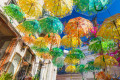 Street decorated with colorful umbrellas in Chora, Aegina